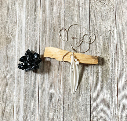 White Feather Necklace from Enlivenadorn by Gwynstone, representing hope and protection, hanging on a delicate snake chain.