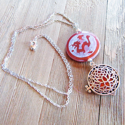 Zen style Peacock and Dragon Etched Carnelian Jewelry on a wooden surface, emphasizing its artisan design.