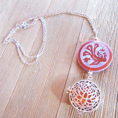 Peacock and Dragon Etched Carnelian Jewelry displayed with essential oils, showcasing its aromatherapy features.