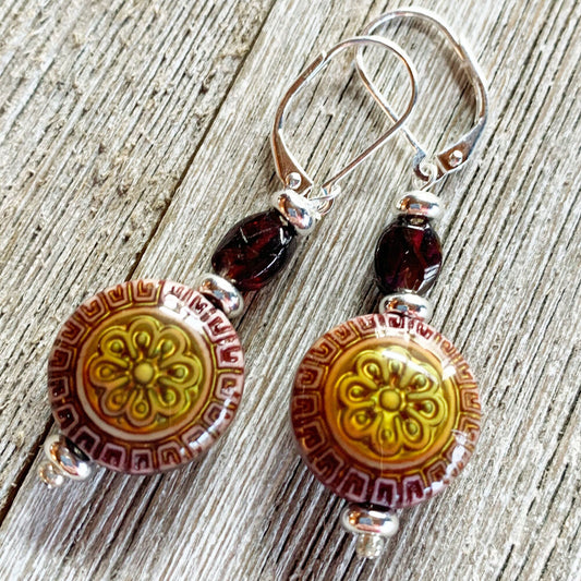 The Garnet Mandala Earrings and Necklace Set features artisan-designed, zen-style mood beads in a boho jewelry look—ideal for those who appreciate meditation-inspired accessories, beautifully displayed on a wooden surface.