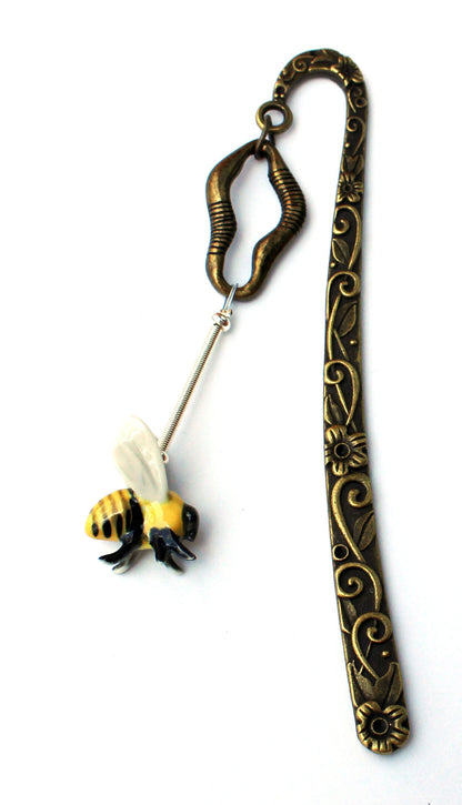 Buzzing Bee Porcelain Bookmark displayed among books, highlighting its decorative role as a place marker for readers and gift for bee lovers.