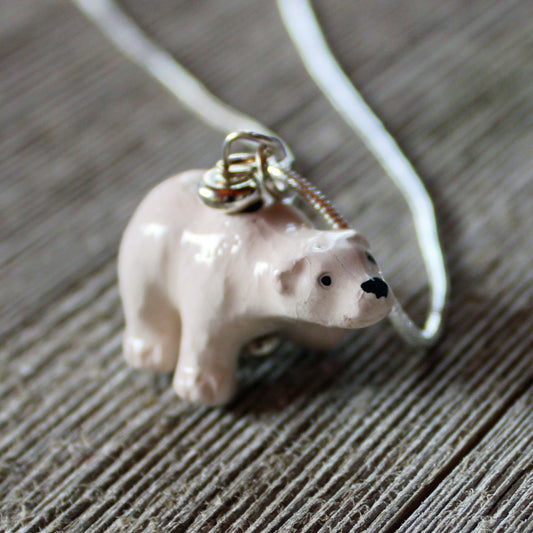 The Hand-Painted Ceramic Polar Bear Necklace—an ideal wildlife animal lover gift—features a ceramic polar bear on a silver chain, offering a unique piece of jewelry for nature enthusiasts.