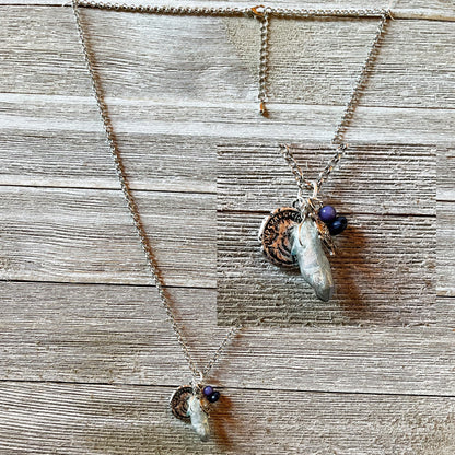 Close-up of the Pirate’s Booty Charm Necklace showcasing its shimmering silver design and unique nautical treasures.