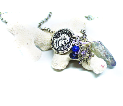 Pirate’s Booty Charm Necklace featuring gemstones, coin doubloons, crystals, and a ship's wheel, part of the BVI Blue Collection.