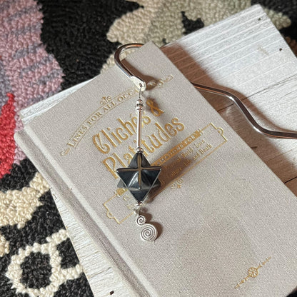 Detailed view of Sacred Geometry Merkaba Bookmark with Hematite showcasing intricately carved silver spine, perfect for meditation and spiritual reflection.