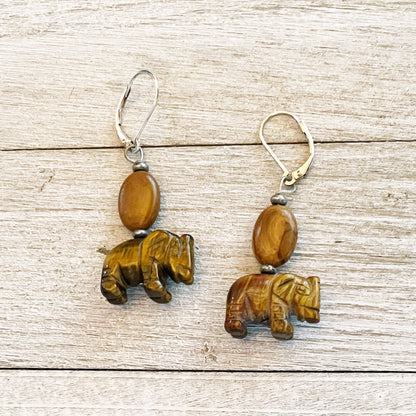 Handcrafted elephant earrings featuring carved tiger's eye stone, perfect for elephant lovers and as a gift for zoo keepers.