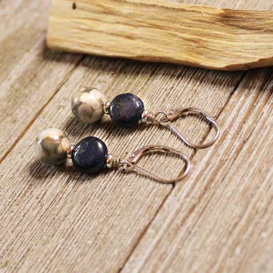 Orbicular Jasper & Lapis Lazuli Earrings—Sterling silver zen jewelry featuring deep blue lapis and orbicular jasper beads—rest atop rustic wood beside light-colored timber.