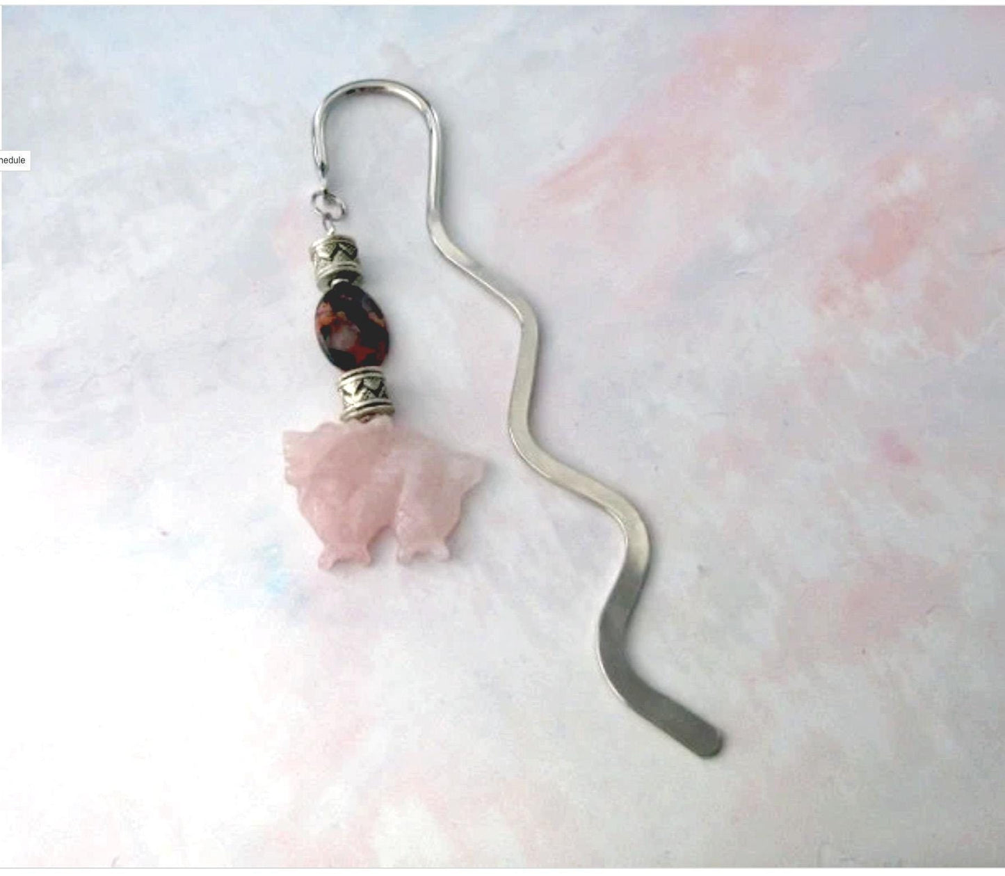 A Dragon Bookmark with a rose quartz carved dragon, perfect for fantasy and mystery readers, is shown as a bullet journal page marker on a light pastel background.