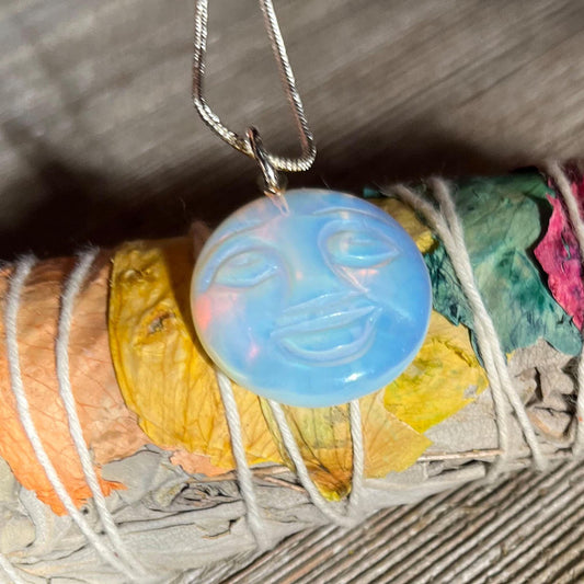 The Full Moon Opalescent Necklace, a celestial-themed accessory for peace and quiet, features a blue opalescent pendant on a silver chain—making an unusual and playful gift.