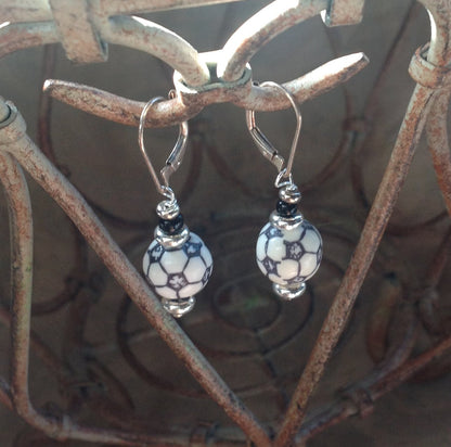 Model wearing Soccer Ball Earrings while watching a soccer game - Soccer Sport Earring - Sport Ball Earrings by Enlivenadorn by Gwynstone.