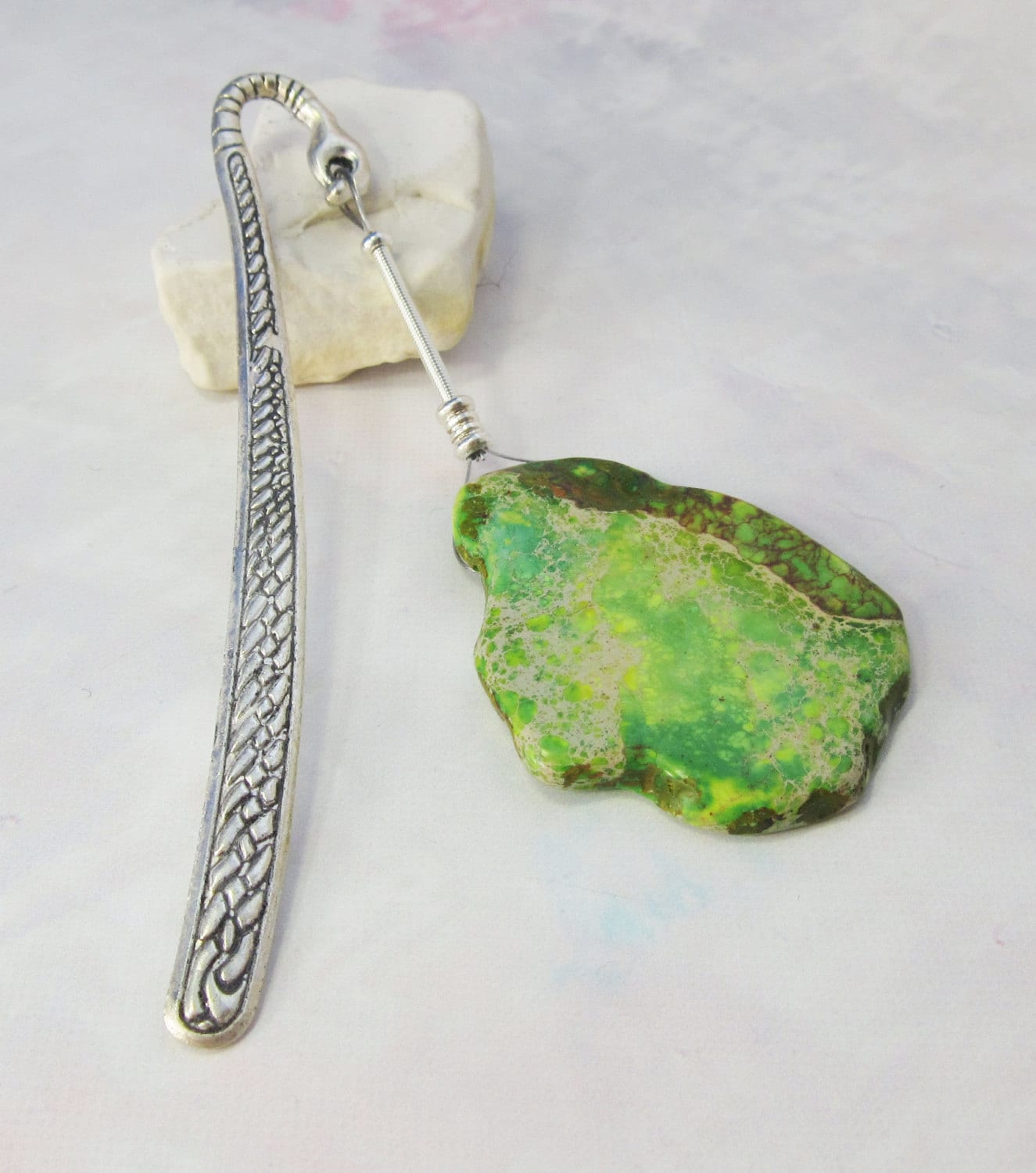 The Impression Jasper Metal Bookmark features a green healing crystal charm in a unique zen design, artisan handcrafted with a detailed pattern. Presented on white with a small stone, it comes gift-boxed—perfect for book lovers.
