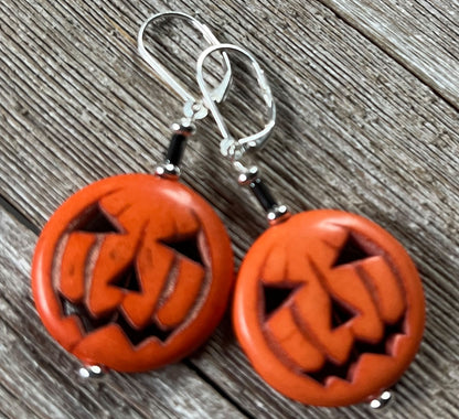 Add a touch of festive fun to your look with the Halloween Theme Earrings by Enlivenadorn by Gwynstone—these playful jack-o-lantern earrings, shaped like orange pumpkins with carved faces, rest on a wooden surface and are the perfect accessory for any spooky celebration.